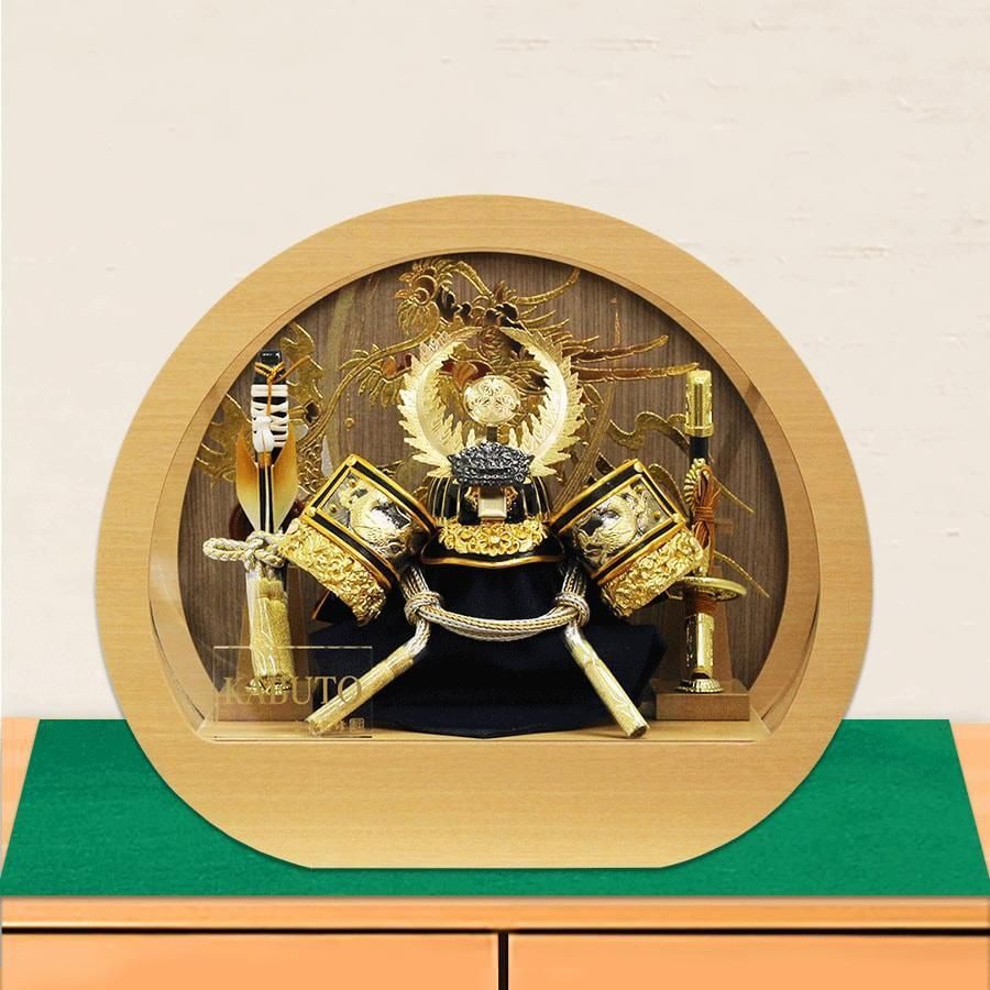 A Tokugawa Ieyasu Helmet, Five-in-One, Offered by Hodo: A Tokugawa Ieyasu No. 5 helmet offered by Hodo, mounted in a white wooden frame and acrylic circular display case. May Festival Doll, crafted by Hodo, featuring a golden Tokugawa helmet, displayed in 
