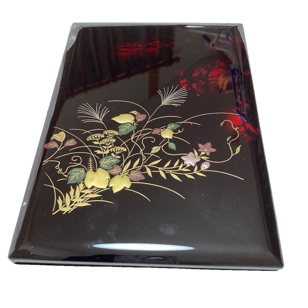 Lacquered Autumn Grass Pattern Address Book, A5 Size: A lacquered address book, featuring a design of golden leaves and autumn grasses on a black background. Design: Lacquerware with floral patterns on a black background Page Type: Standard Purpose: For