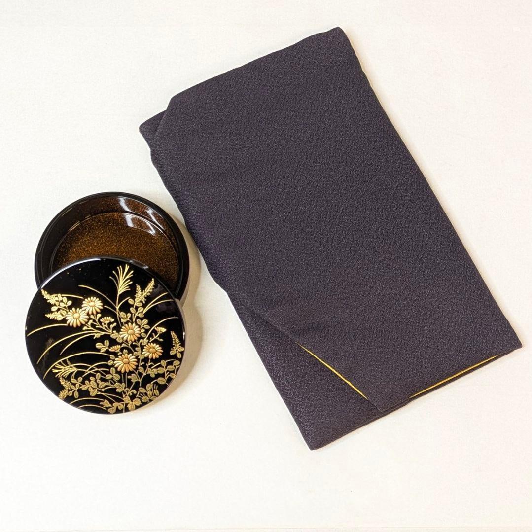 Autumn Grass Incense Box, with Stand and Furoshiki.: The set includes an incense box made of wood powder resin, adorned with a maki-e (gold lacquer) design of autumn grasses, and a furoshiki (wrapping cloth) with a stand. As it is a traditional