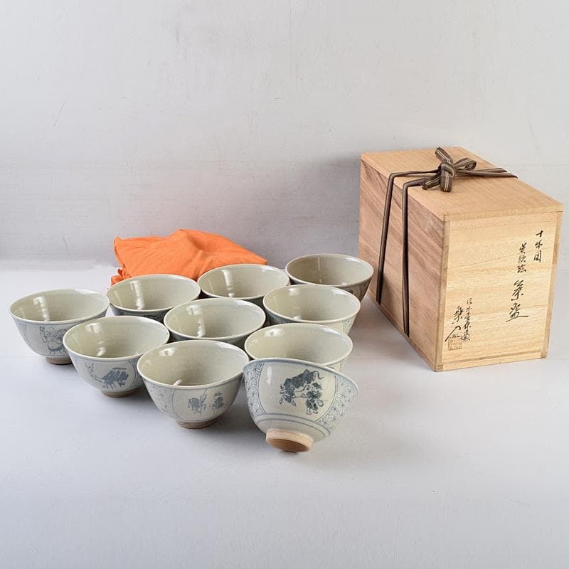 Tea Ceremony Utensils: Shigaraki Ware, created by Suetani Rakuyu, a set of 10 tea bowls, decorated: Tea Ceremony Utensils: Shigaraki Ware, crafted by Suetani Rakuyu, a set of 10 tea bowls, decorated with the Ten Oxherding Pictures, accompanied by a cloth bag and box. Dimensions: Approximately 7 cm i