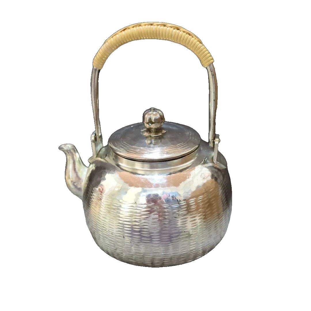 A circular teapot with a hammered pattern, produced by Shuhodo, featuring a silver finish, designed (1 of 7)