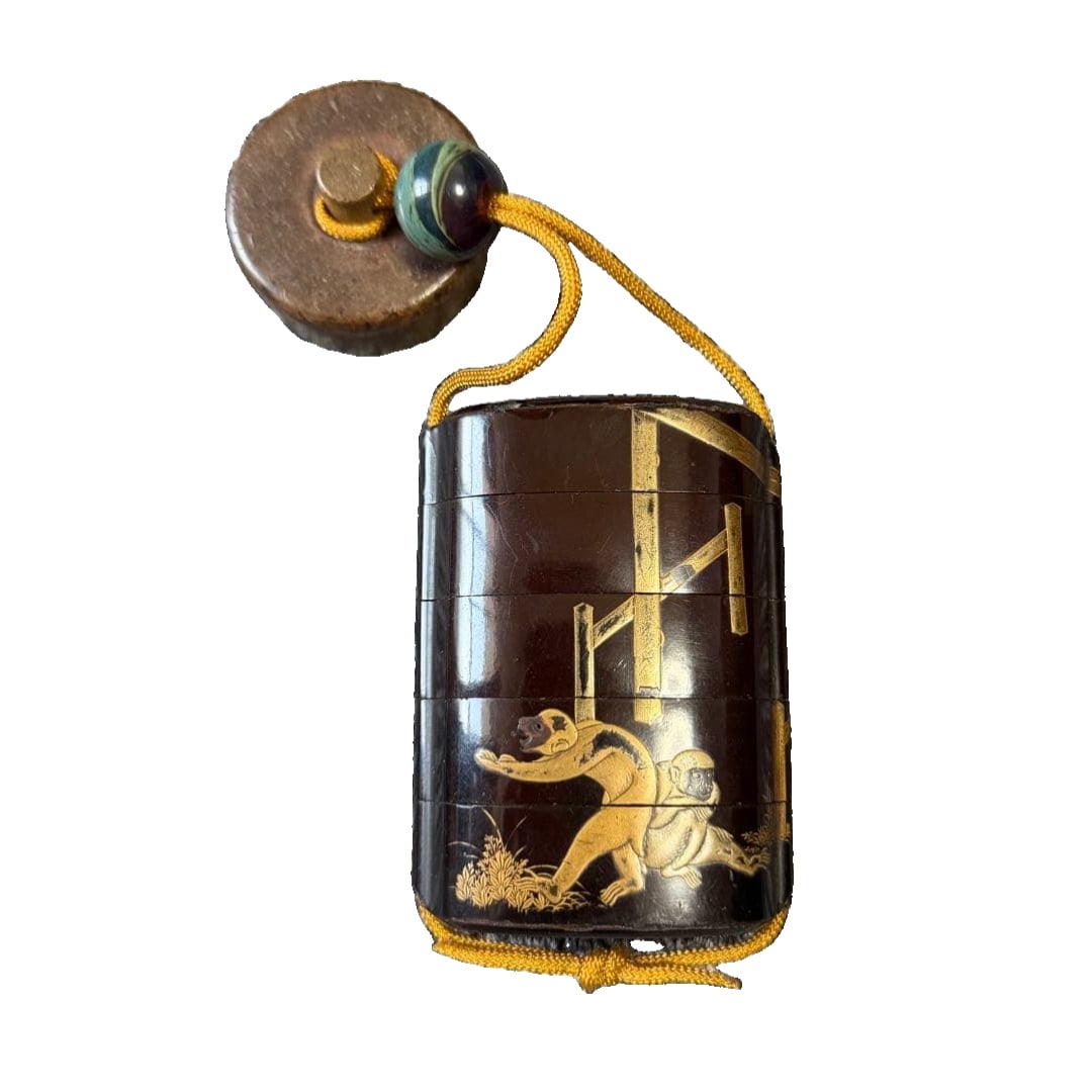 A gold lacquer inrO (small container), decorated with motifs of monkeys and horses, with a cord: Gold Lacquer InrO (small container), decorated with motifs of monkeys and horses, with a cord fastener and netsuke (miniature ornament). This piece previously belonged to a family, and the gold lacque