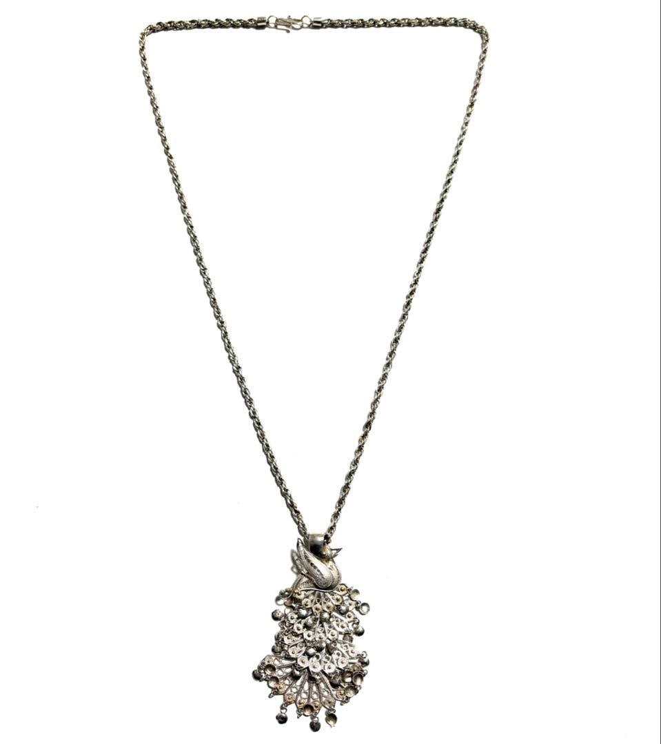 Second-hand - Vintage Peacock Pattern Silver Wire Necklace/Pendant: This is a vintage peacock pattern silver wire necklace/pendant. This vintage pendant/necklace features a unique peacock feather fan-shaped design. The wings are designed with an "adjustable/articulate