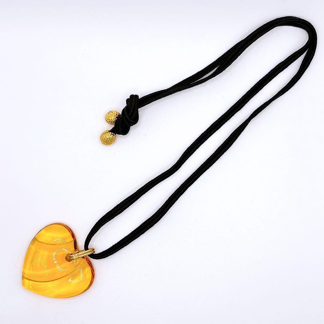 Second-hand - Baccarat Crystal Heart-Shaped Long Necklace, Yellow: This heart-shaped pendant necklace is set with Bacara crystal, which is renowned for its extreme transparency. Depending on the angle of light, it emits a luxurious, gold-like luster. The brand logo i