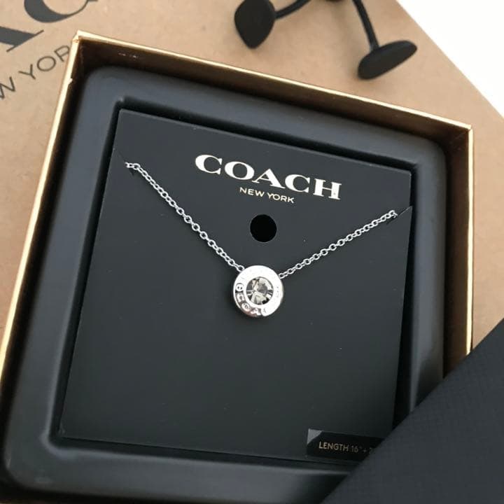 Second hand - COACH silver necklace: Purchase Location: COACH Factory on the West Coast of the United States "Product Details" Condition: Brand New Color: Silver Pendant: Approximately 1 cm wide x 1 cm high Chain Length: Approximately 39