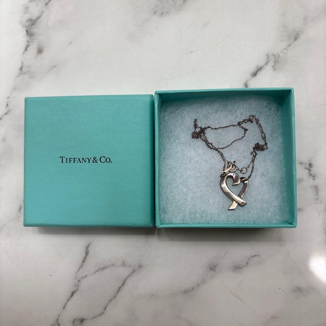 Second-hand - Tiffany & Co. 925 silver necklace, with heart-shaped ribbon.: A silver necklace produced by Tiffany & Co., featuring heart and ribbon motifs, and engraved with a 925 sterling silver mark. Brand: Tiffany & Co. Design: Heart and ribbon motifs Material: Silver