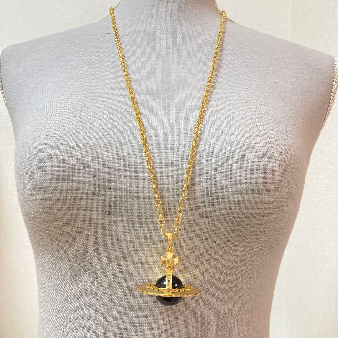 Second Hand - Vivienne Westwood | Small Orb Pendant Necklace: This necklace features Vivienne Westwood's iconic small orb, made in a gorgeous gold and unique black color scheme. This unisex piece, with its classic design and modern color scheme, is very eye-catc