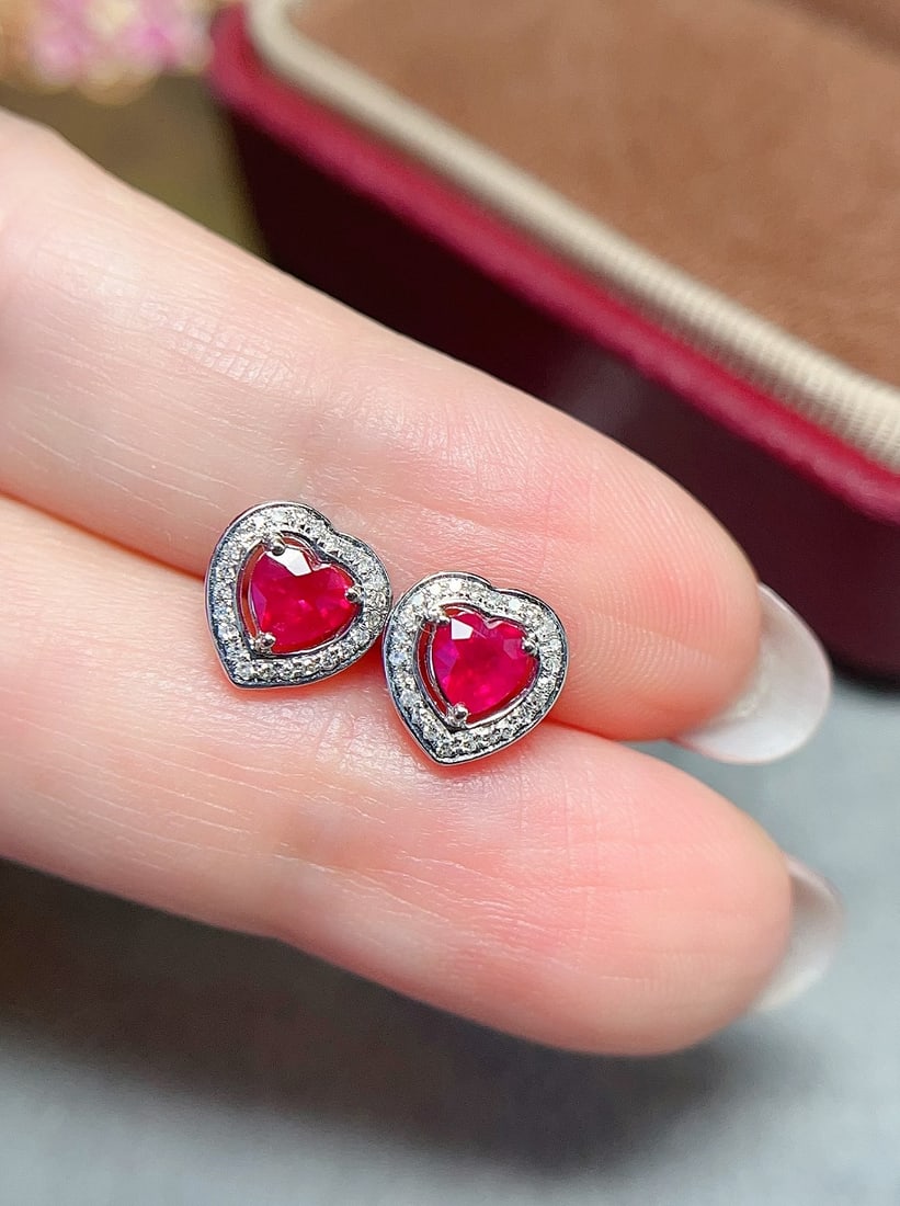 18K Gold Ruby Earrings: These earrings are meticulously crafted in 18K gold, set with heart-shaped rubies displaying a rich pigeon blood red color, sweet and captivating, making them truly eye-catching. The radiance of the r