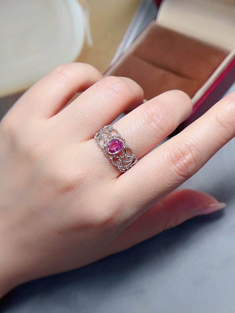 18K gold sapphire ring: This 18K gold sapphire ring features a unique pinkish blue sapphire at its center, emitting an incredibly sweet vibe. The ring is set with glass-filled sapphires, clean and crack-free, perfectly showc