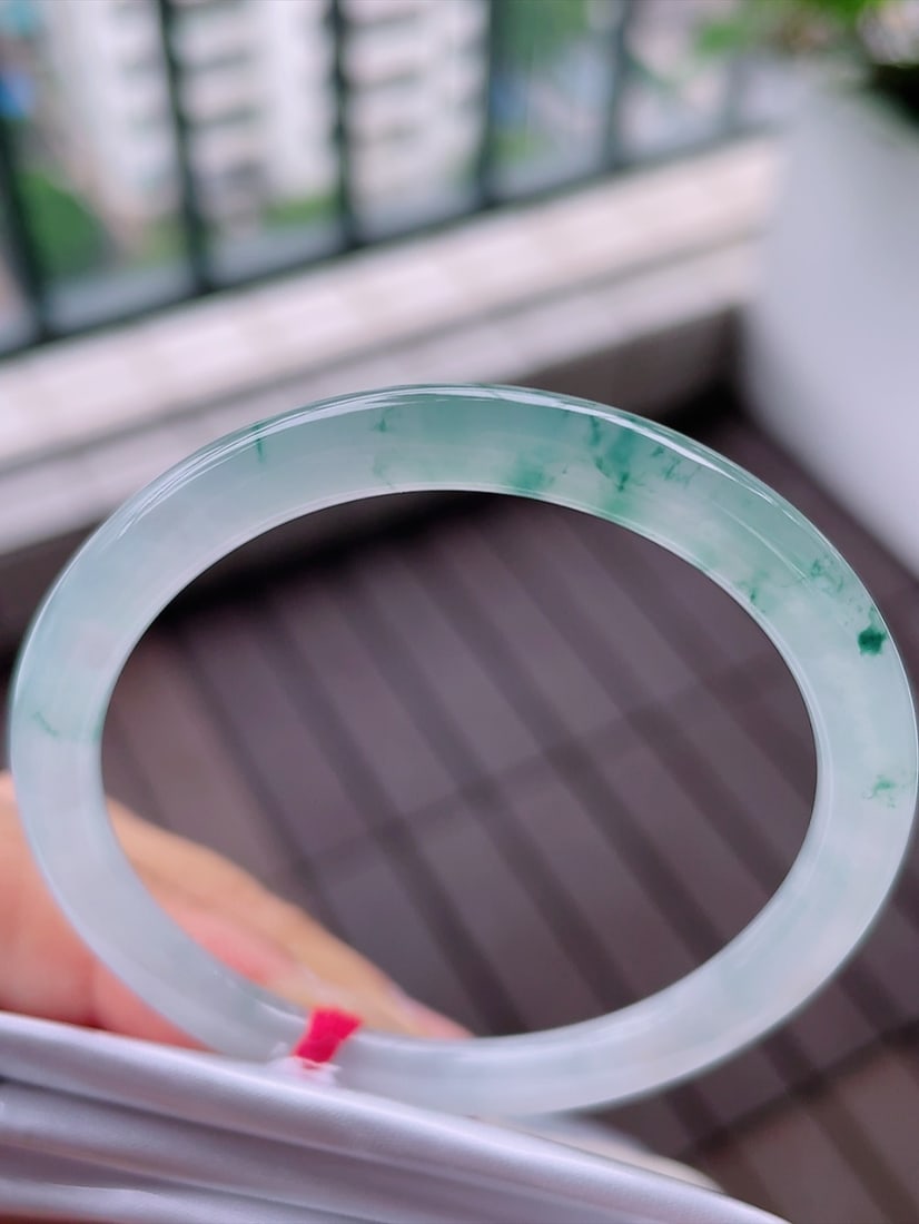 jadeite round bar bracelet: This jadeite round bangle showcases unparalleled elegance and charm with its floating flower design and lustrous texture. The perfect craftsmanship combined with superior quality water makes it an