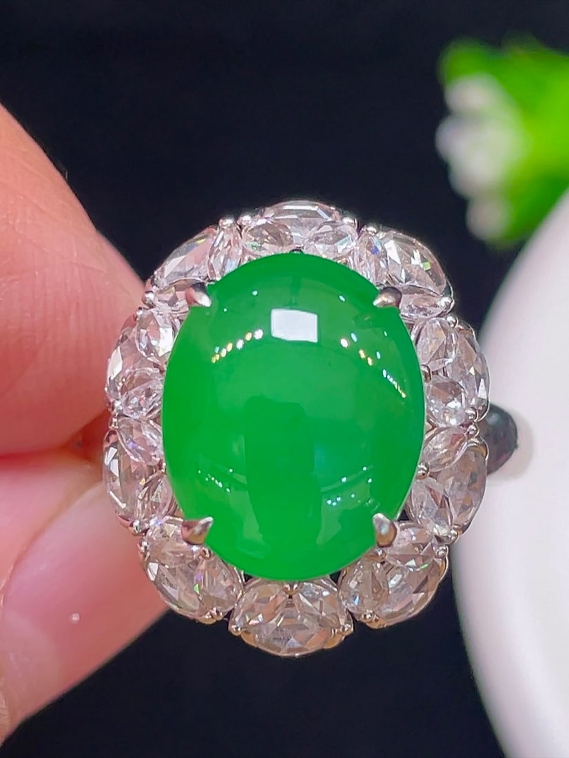 18K gold diamond jadeite ring: This ring features a high-quality ice yang green jadeite as the main stone, showcasing a large and full design. The transparent and moist texture is stunning. The jadeite is delicate and brightly colo