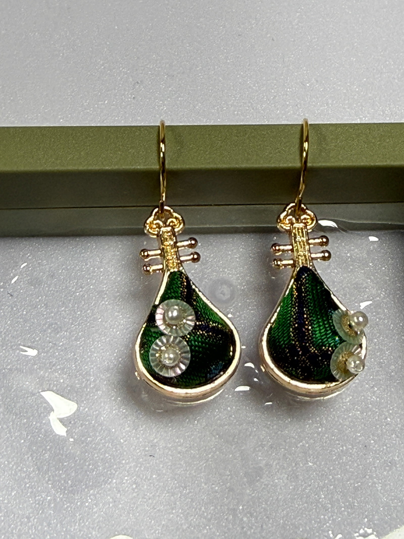 Song Brocade Pipa Earrings: Handmade Song Brocade Pipa Earrings These unique earrings are inspired by the elegant shape of the traditional Chinese pipa (lute) and crafted using exquisite Song Brocade silk fabric, a historic Chin