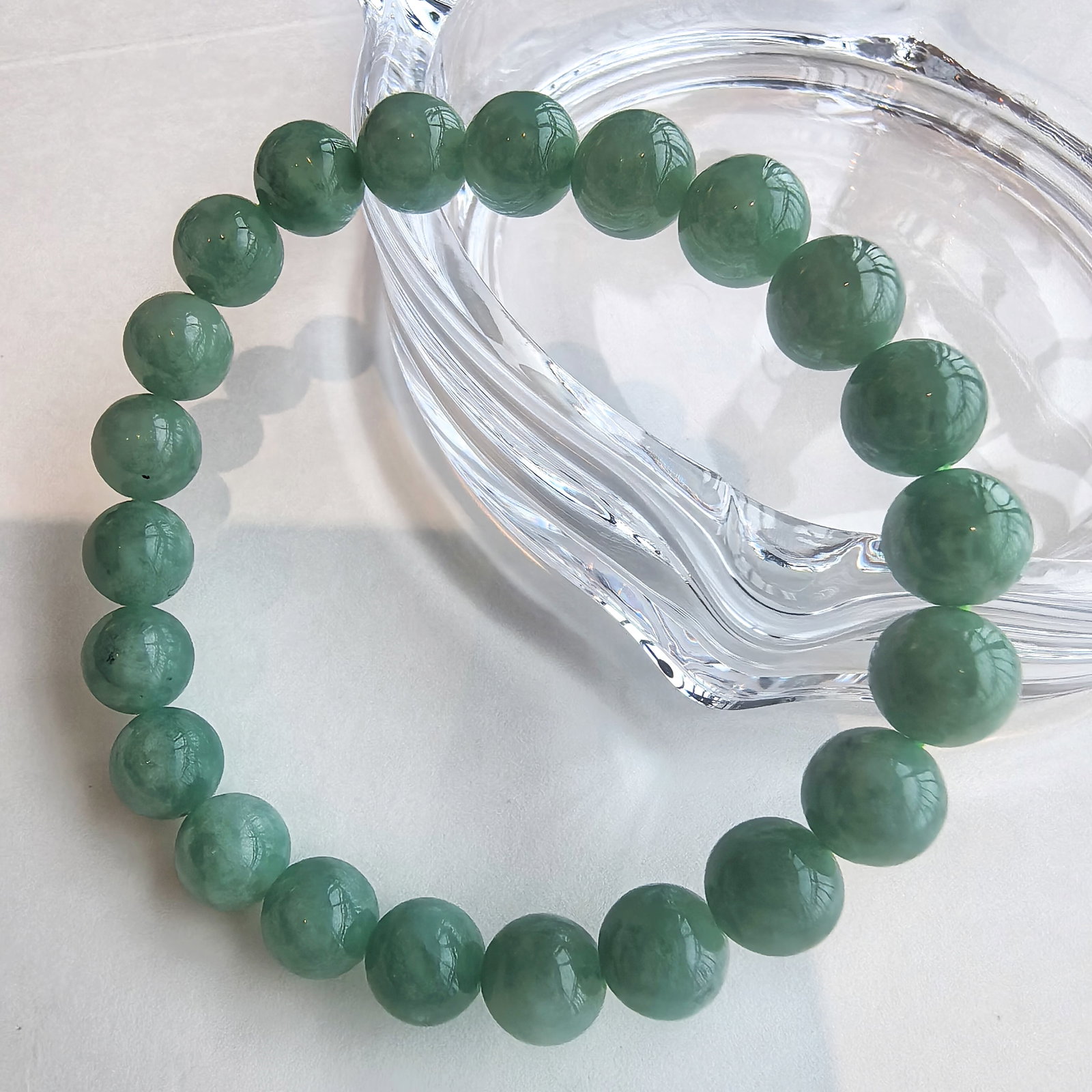 Natural Jadeite Bracelet 12–13mm A Grade Green Jade Jewelry: This natural jadeite jade bead bracelet is composed of matching material, carefully selected for its smooth texture and consistent color. The beads measure approximately 12–13 mm in diameter, each f
