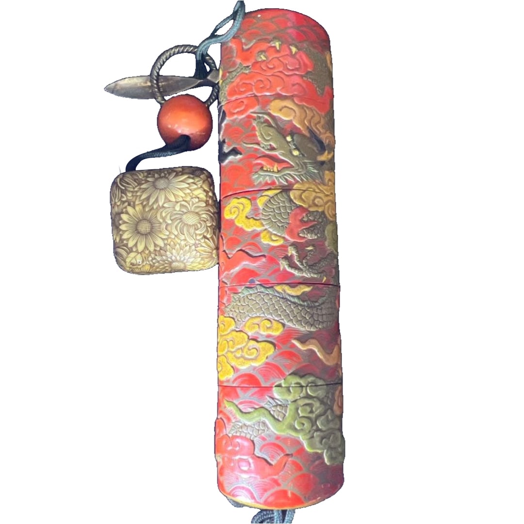 Edo period, lacquered five-tiered print cage with dragon and gold takamaki-e, finely crafted with a: Edo period, lacquered five-tiered incense box with dragon and gold takamaki-e decoration, finely crafted with a Daoteng Zai signature netsuke, natural red coral bead, 73 grams.
