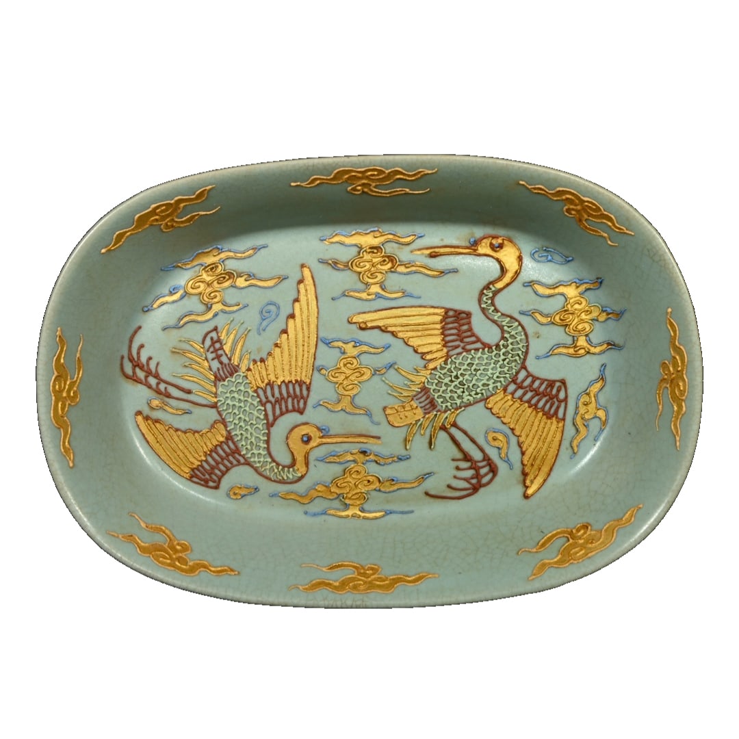 Ru kiln official script powder coated gold painted immortal crane pattern narcissus basin: This Song Dynasty Ru kiln official marked Narcissus basin has a rectangular shallow belly shape, with harmonious proportions and smooth lines. It features the typical Ru kiln sky-blue glaze, with a de