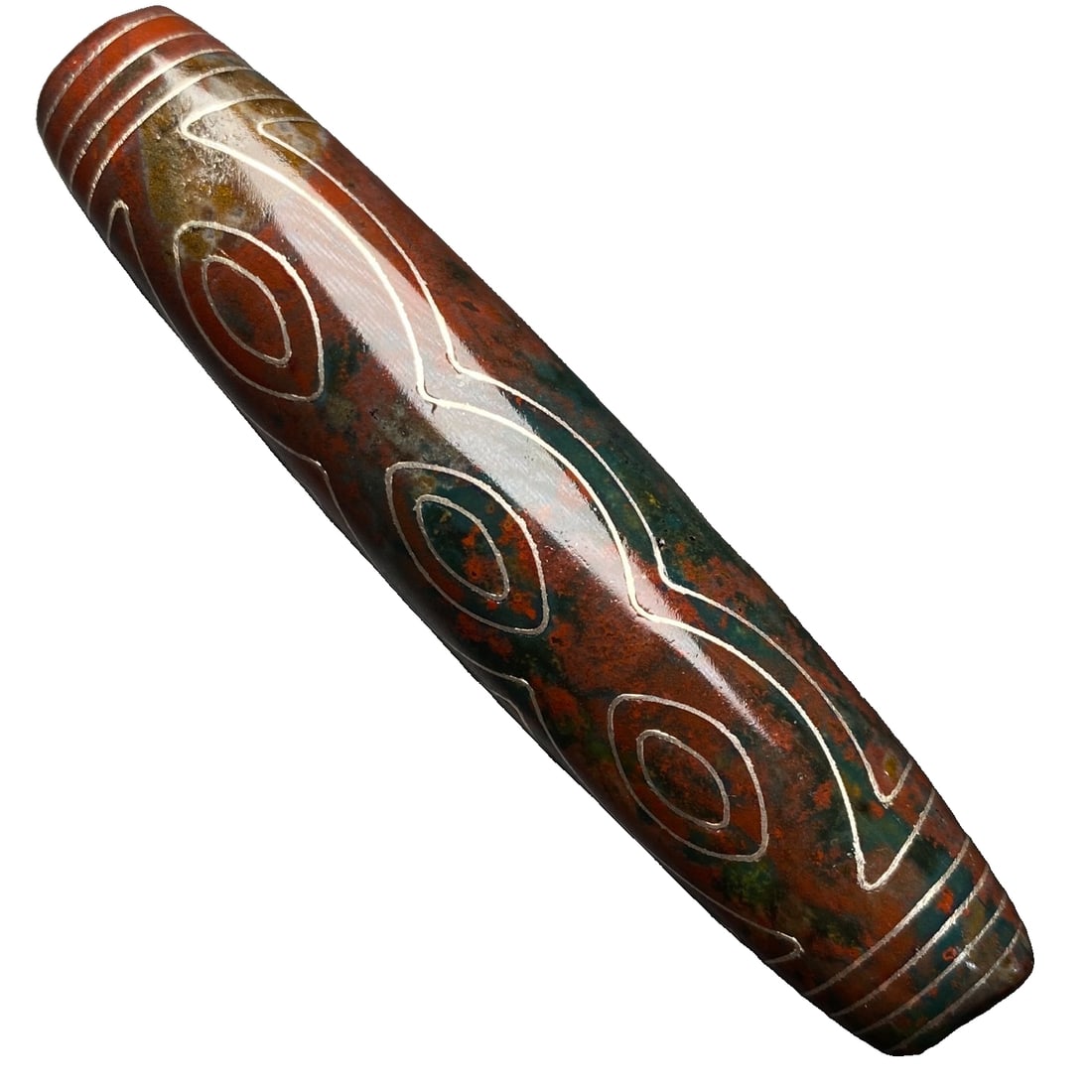 Inlaid with silver wire, filled with cinnabar, a six-eyed dzi bead.: Embedded with silver wire and filled with cinnabar, this six-eyed dzi bead measures 77x16 millimeters and weighs 34.5 grams. The core symbolizes the six paramitas, which are generosity, morality,