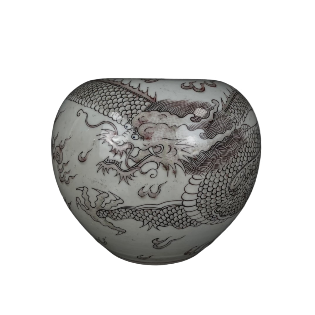 Kangxi period, Qing Dynasty, enameled coral-ground apple-shaped vase.: A Kangxi period apple-shaped vase with a red dragon playing with a pearl amidst auspicious clouds design. It stands 17cm tall and has a diameter of 18cm, with a round and bulging body shape,