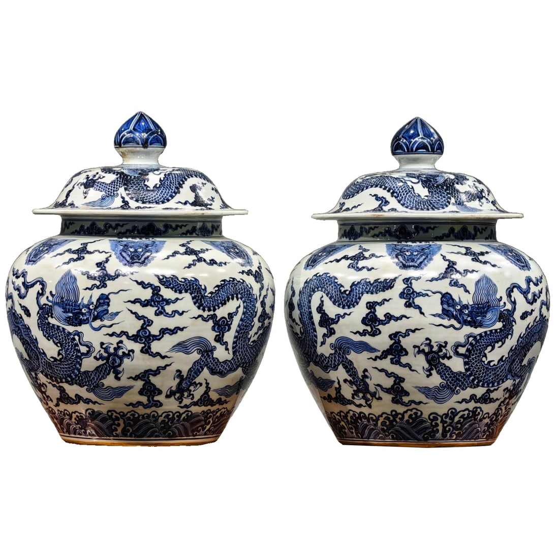 A pair of large-sized blue and white dragon-patterned vases with covers, made during the Xuande: A pair of large-sized covered jars with Qing Dynasty Xuande reign mark, featuring dragon motifs amidst clouds in underglaze blue. They measure 66cm in height and 53cm in width. The entire surface of