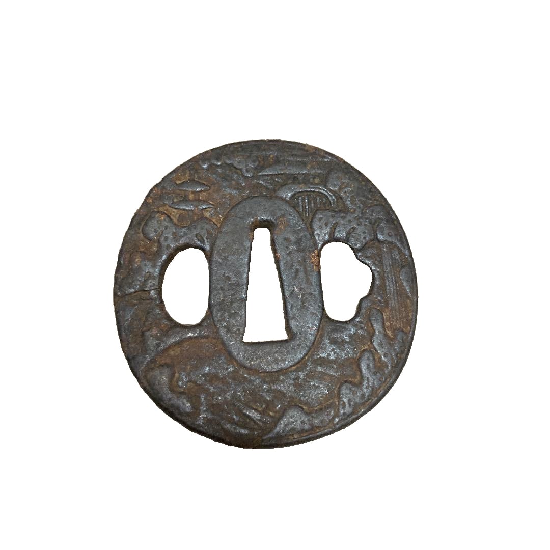 Iron tsuba, adorned with carved decorative motifs.: Circular Iron Sword Guard (Tsuba), featuring carved decoration. Shape: Circular Material: Iron