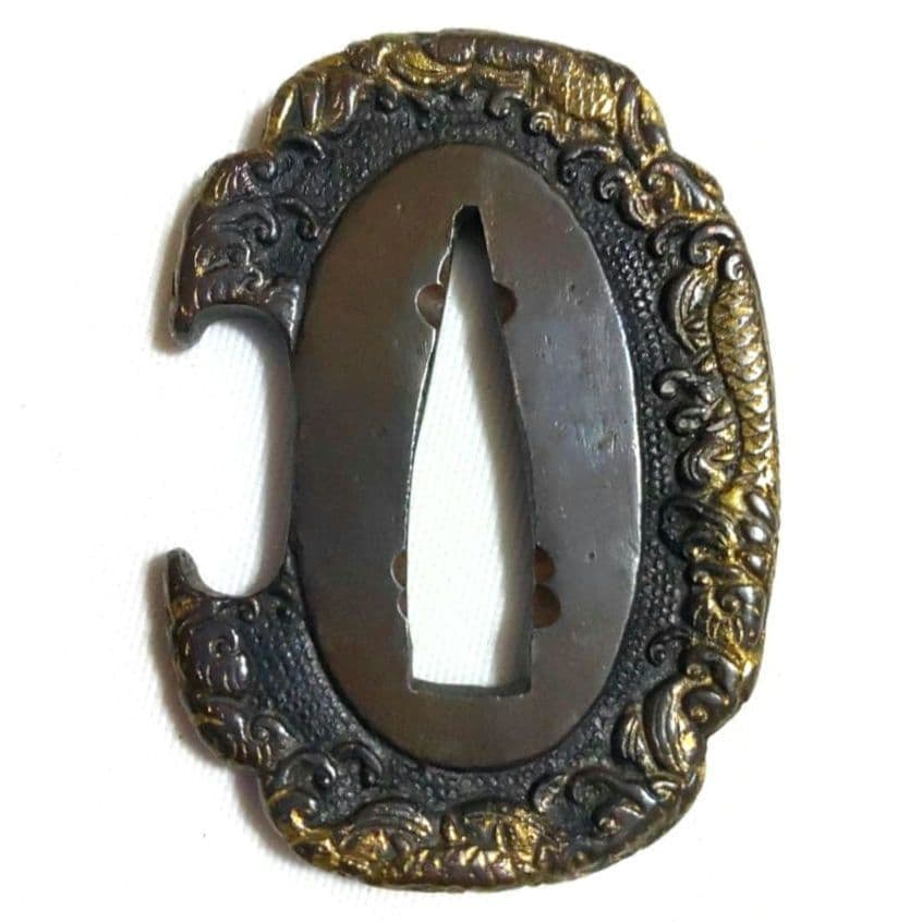 A fashionable wave-patterned dragon-shaped sword guard (tachi), with a copper fish roe ground, in: This piece is a pommel in the shape of a pear, adorned with high relief wave patterns and gold inlaid dragon motifs. The image of the dragon is vividly lifelike, as if leaping out of the surging waves