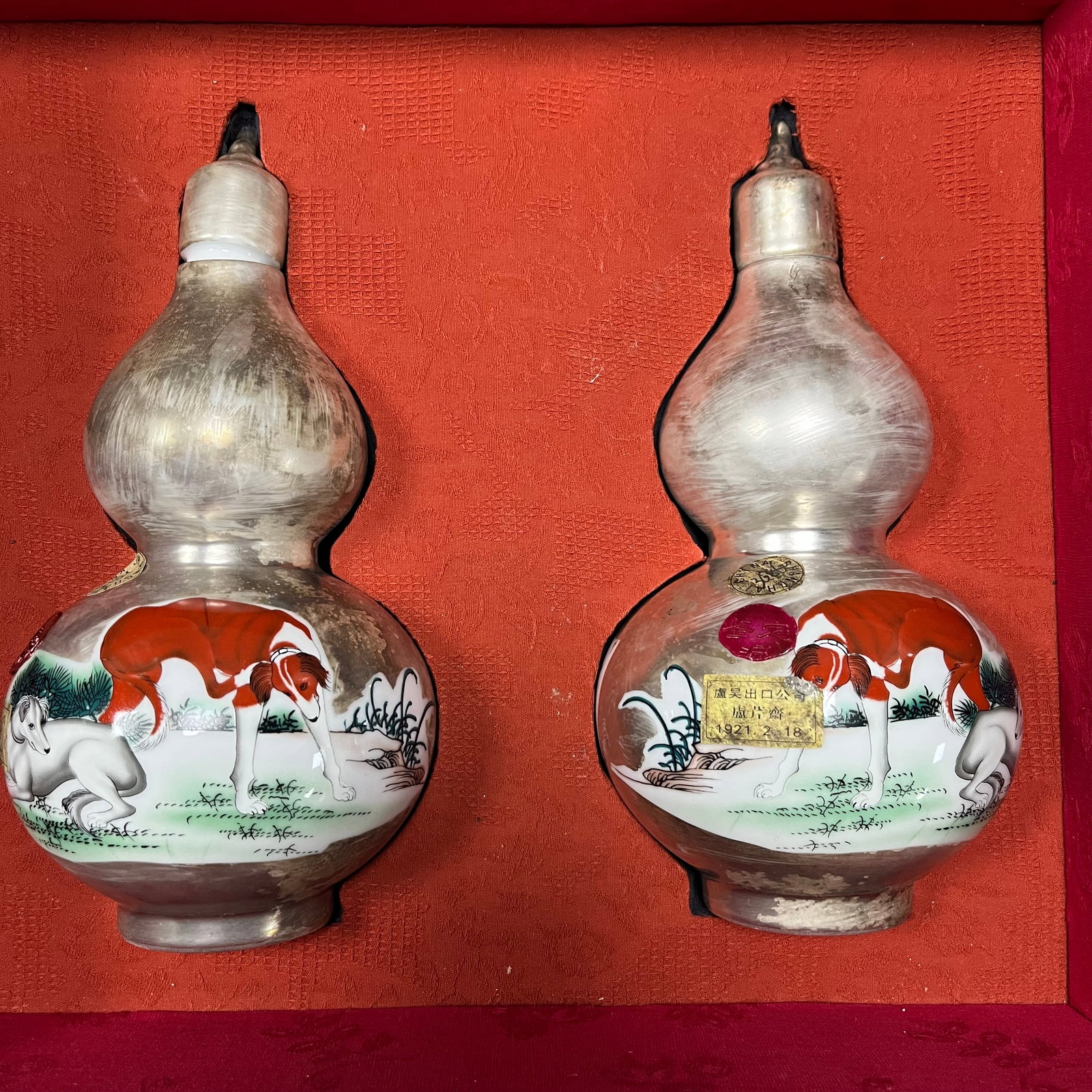 Qing Dynasty Tin-mouthed Famille Rose Gourd-shaped Vase: This collection comprises a pair of gourd-shaped vases (circa late 19th-early 20th century) decorated with famille rose enamels and depicting two dogs, painted by Giuseppe Castiglione (Lang Shining). 