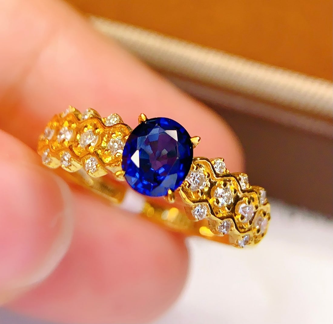 18K Gold Natural Sapphire Ring: This ring is meticulously crafted in 18K gold, featuring a natural sapphire that exudes a captivating brilliance. It is adorned with 22 diamonds, adding a touch of luxury. The overall design is