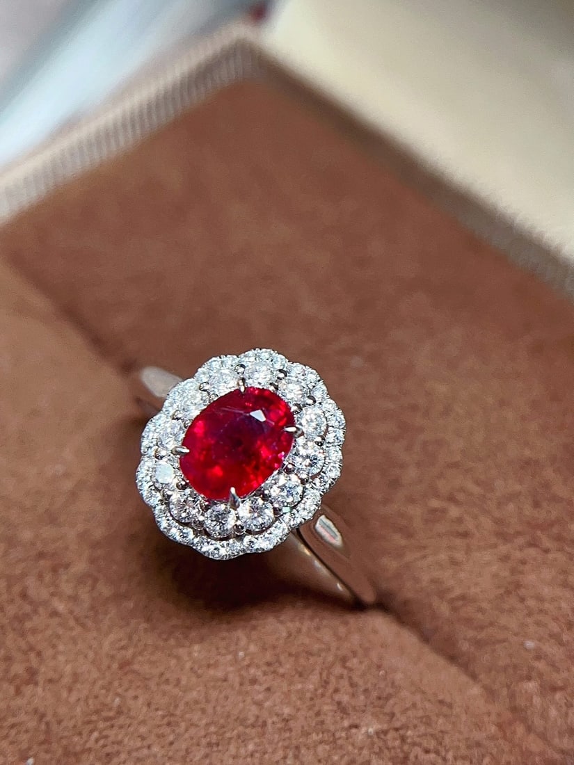 18K Gold Pigeon's Blood Ruby Ring: This ring is crafted from 18K gold, featuring a vivid pigeon's blood ruby that exudes an aura of elegance and nobility. The full diamond setting enhances its brilliance, making it suitable for any occ