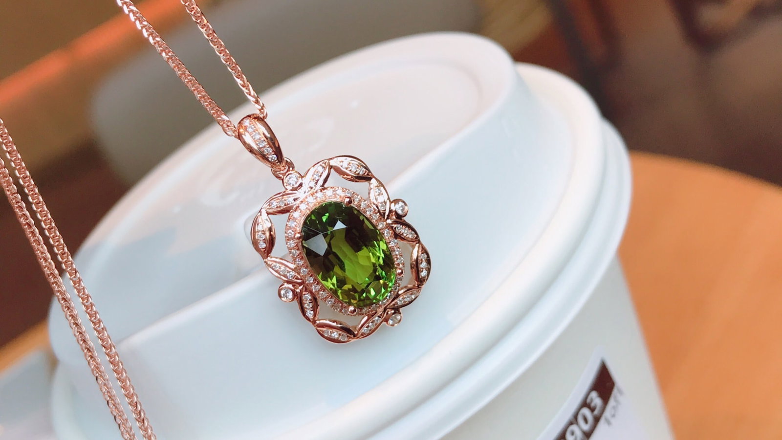 18K Gold Natural Tourmaline Pendant: This pendant is crafted in 18K gold with a natural tourmaline that is crystal clear. Its simple yet elegant design is enhanced by the brilliance of 82 diamonds. (Total weight 2.74g, stone weight