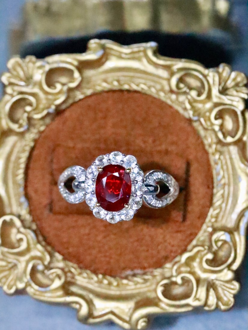 18K Gold Natural Unheated Ruby Ring: This ring is meticulously crafted in 18K gold, showcasing the natural allure of the unheated ruby. The main stone boasts a rich hue, complemented by diamonds and white sapphires, adding an elegant tou