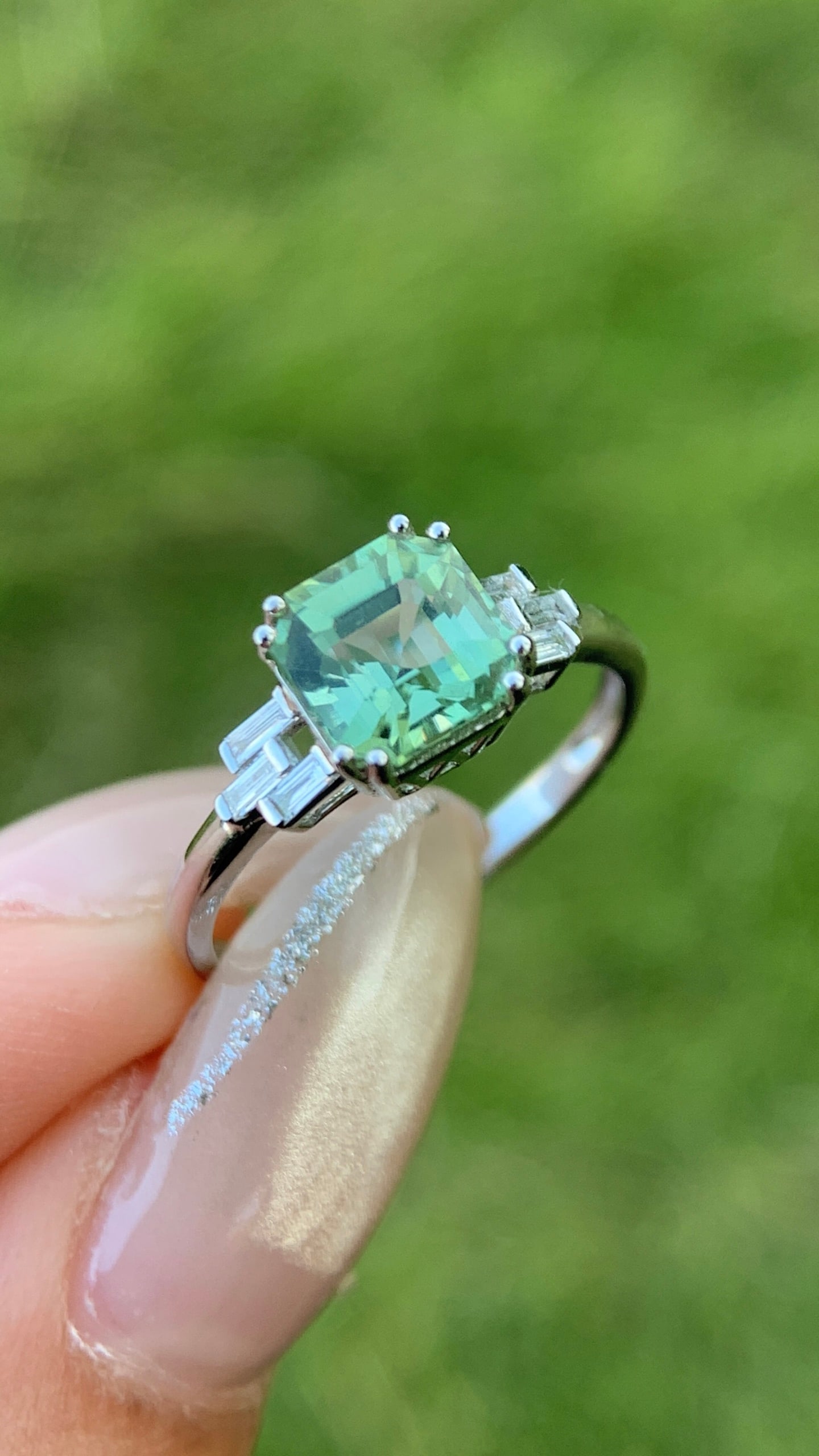 18K Gold Green Tourmaline Ring: This ring captures the essence of spring with a green tourmaline, its minty green hue sparkling delicately in the sunlight. (Main stone 1.15 carats, side stones 0.091 carats, total weight 1.95 grams)