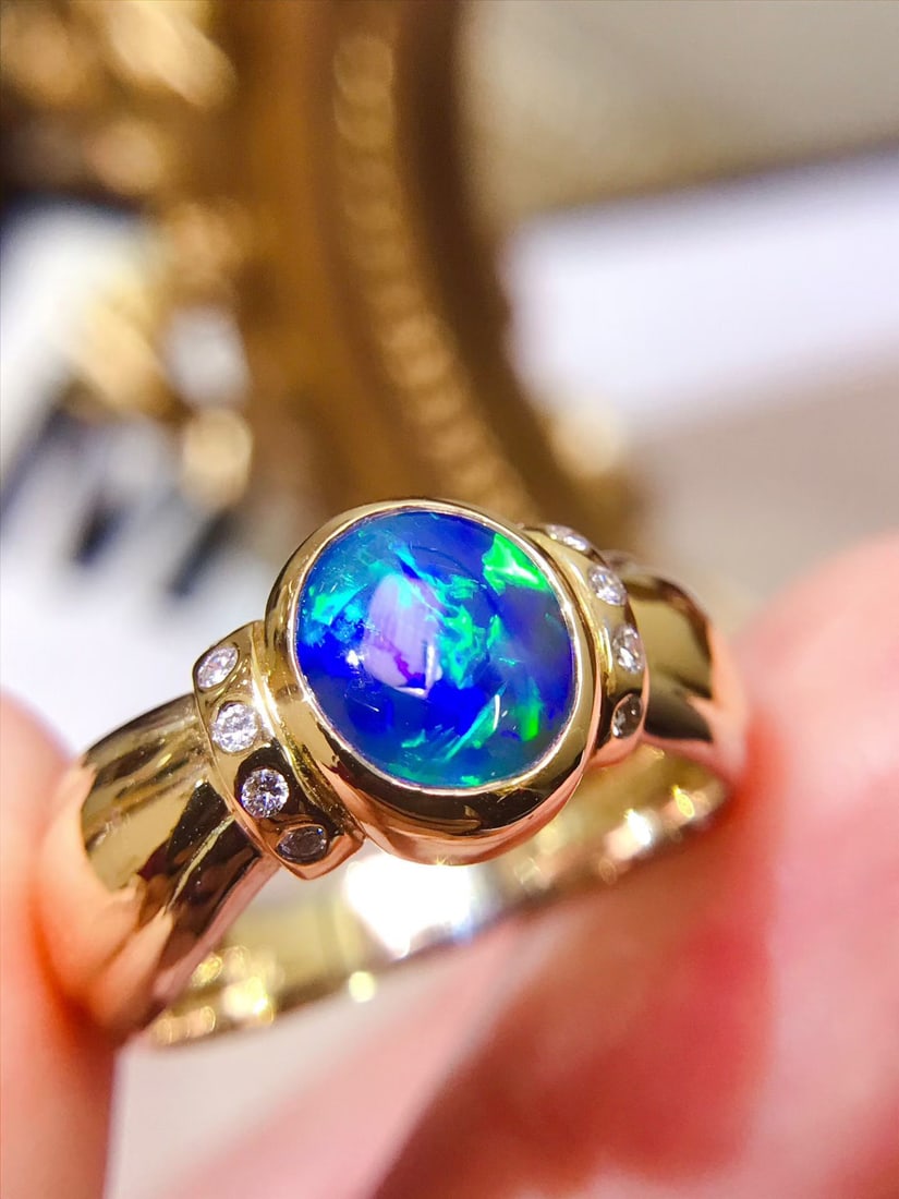 18K Gold Natural Black Opal Ring: This ring is meticulously set in 18K gold, showcasing the unique color patterns of the black opal, which are truly breathtaking. Its exquisite craftsmanship and substantial texture exude elegance and