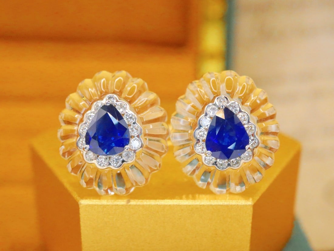 18K White Gold Royal Blue Sapphire Earrings: These earrings are crafted from 18K white gold, featuring royal blue sapphires that exude an aura of elegance and nobility. The deep hue of the sapphires is beautifully complemented by the brilliance