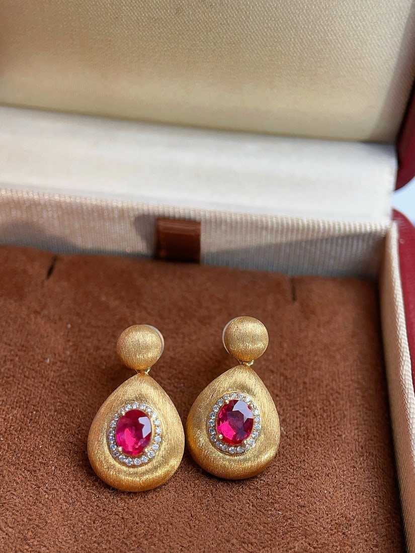 18K Gold Natural Unheated Ruby Earrings: These earrings are meticulously crafted in 18K gold, showcasing the crystal-clear and bright fire of unheated pigeon blood rubies. The handcrafted brushed finish adds a touch of vintage elegance. Perf