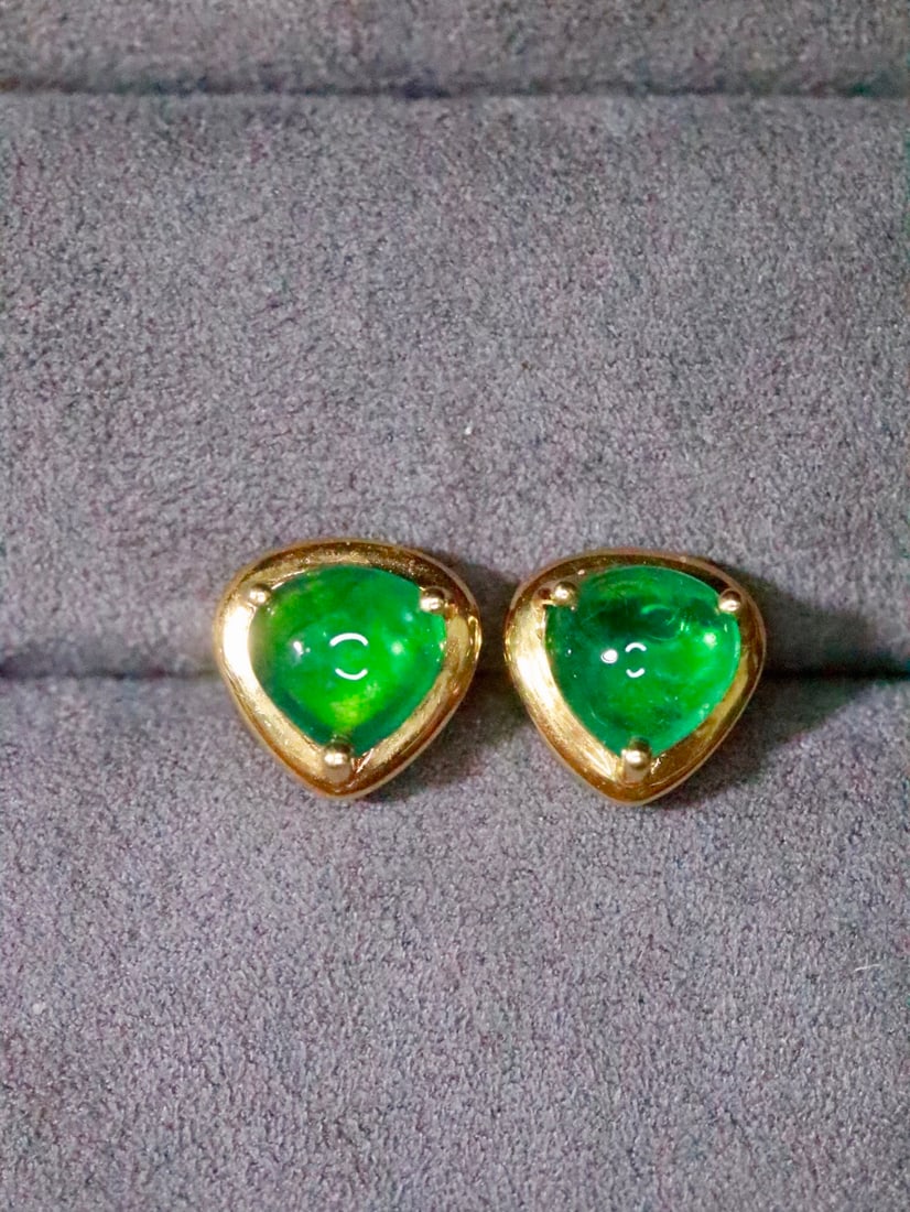 18K Gold Emerald Earrings: These earrings are meticulously crafted in 18K gold, featuring emeralds with a lush green hue. The heart-shaped design adds a playful elegance, perfectly showcasing a sophisticated charm. (Main stone