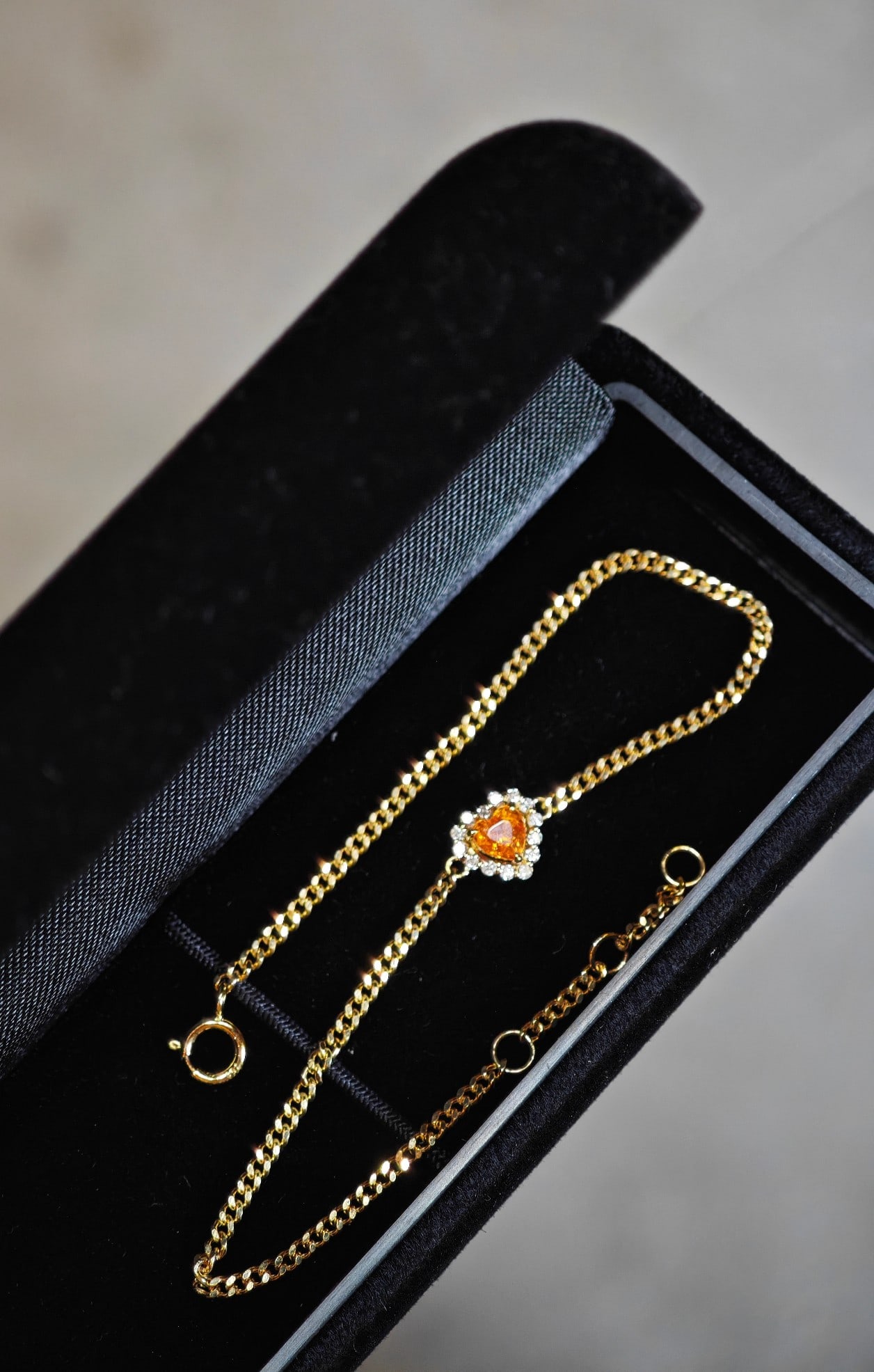 18K Gold Heart-Shaped Fanta Stone Diamond Bracelet: This bracelet features a heart-shaped Fanta stone surrounded by full diamonds, resembling a radiant halo. Its design is as soft and delicate as silk, exuding elegance when worn.