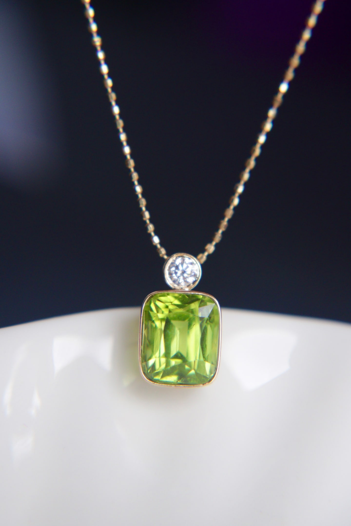 18K Gold Natural Peridot Pendant: This pendant is meticulously set in 18K gold, showcasing the natural allure of peridot. The main stone exhibits an enchanting apple green color with transparent crystal quality, perfect for those