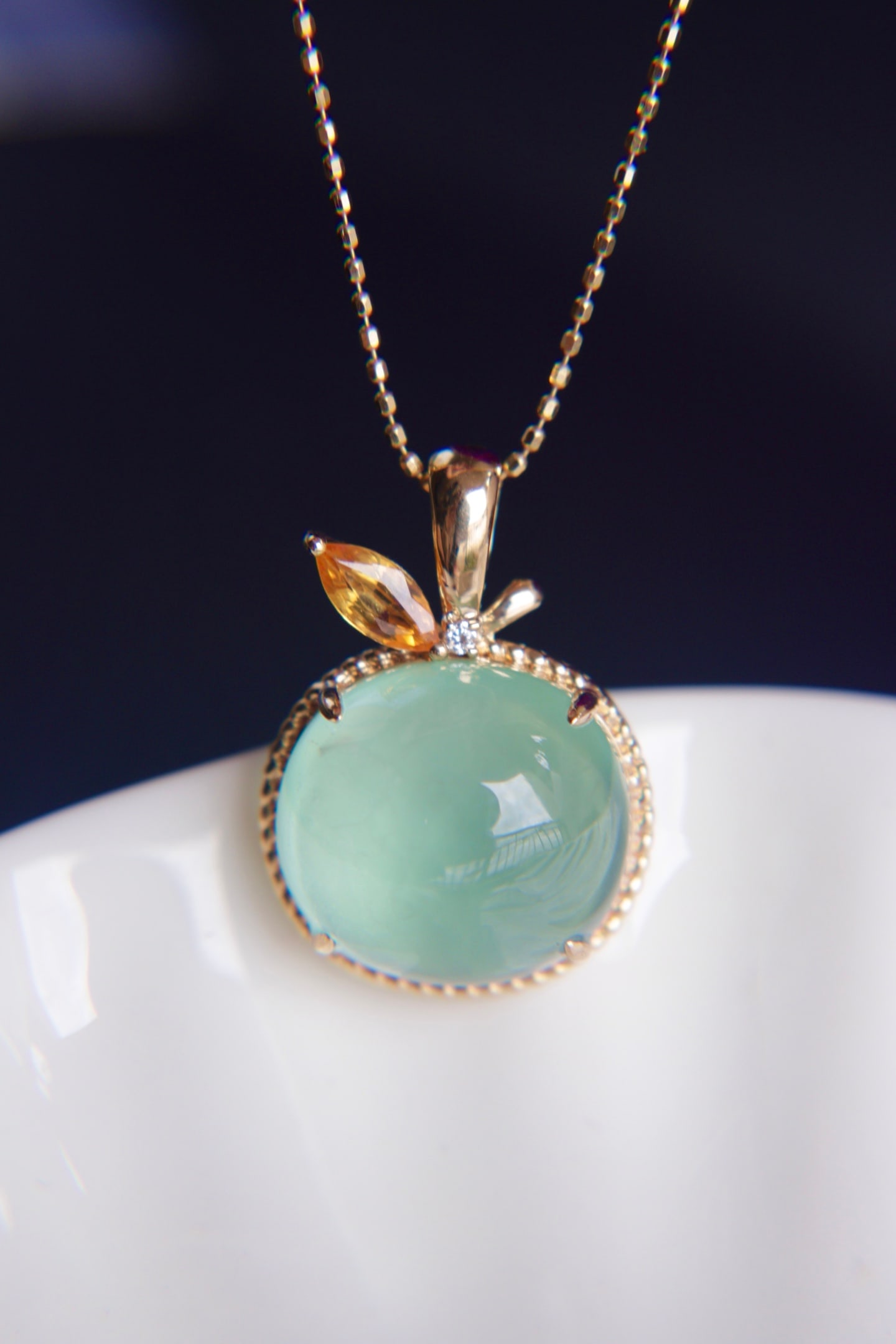 18K Gold Prasiolite Diamond Pendant: This pendant is meticulously crafted in 18K gold, set with a lustrous prasiolite weighing 10.9 carats, showcasing its captivating color. Complemented by South African diamonds, it adds a touch of