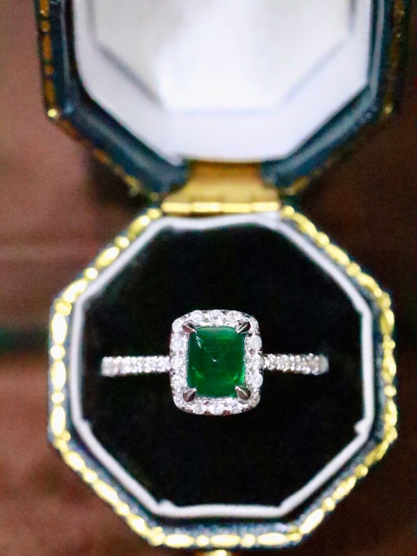 18K Gold Natural Emerald Ring: This ring is meticulously crafted in 18K gold, set with a brilliant emerald that exudes a captivating glow. Complemented by exquisite diamonds, it adds an unparalleled elegance. (Main stone 0.84
