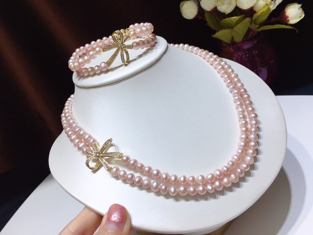 Natural Pearl Necklace and Bracelet Set: This natural pearl set consists of an elegant double-layered necklace and bracelet, with pearls that are nearly round and emit a captivating luster. Each pearl is of natural color, approximately