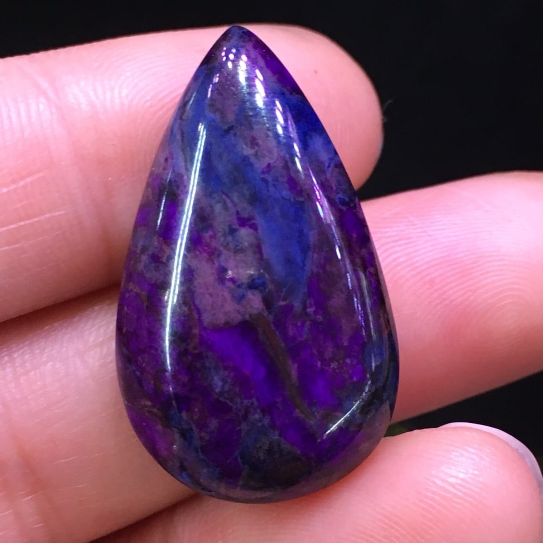 Sugilite Pendant: This sugilite pendant features an elegant teardrop shape with captivating colors. Its exquisite design and natural hues make it a desirable collectible. When worn, it exudes unique charm and style. (2
