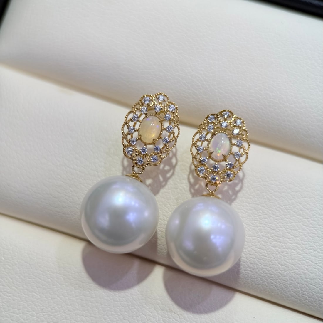 18K Gold Opal Earrings: Vintage-style opal earrings showcasing a myriad of colors, surrounded by white zircon stones, elegantly charming when worn. (Beads 11-12mm)