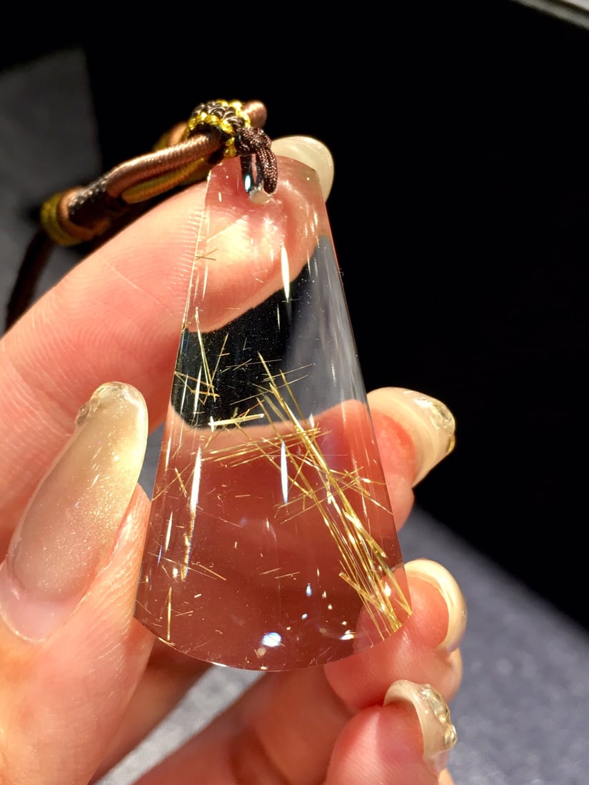 Natural Rutilated Quartz Pendant: This natural rutilated quartz pendant showcases unique charm with its pure crystal and golden hue. Each piece is meticulously hand-polished, presenting an elegant texture. Ideal for collectors