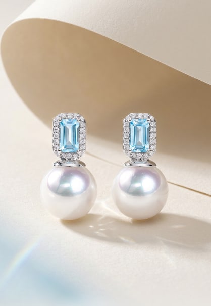 18K Gold Blue Topaz Akoya Pearl Earrings: These earrings feature 18K gold set with blue topaz and Akoya pearls, showcasing a refreshing color palette and a noble jewelry aura. The Akoya pearls measure 9-9.5mm in diameter, round with slight bl