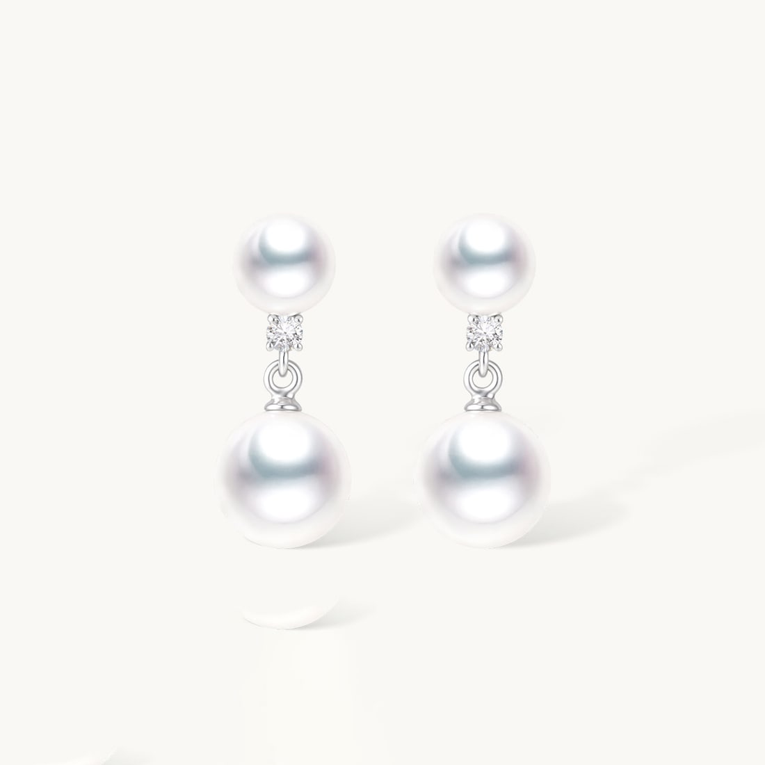 18K Gold AKOYA Pearl Earrings: These earrings are meticulously crafted in 18K gold, featuring elegant AKOYA pearls in a classic round design. Each pearl is carefully selected, exuding a captivating luster. The diamonds set on the e