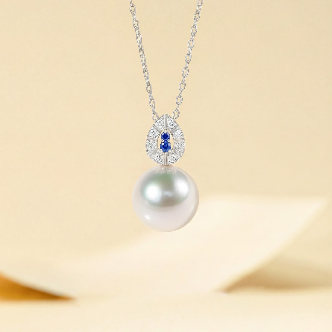 18K Gold Natural Sapphire Seawater Pearl Pendant: This pendant is meticulously crafted in 18K gold, set with natural sapphire and seawater pearl, showcasing a perfect blend of elegance and luxury. The pearl's intense luster complements the deep hue o