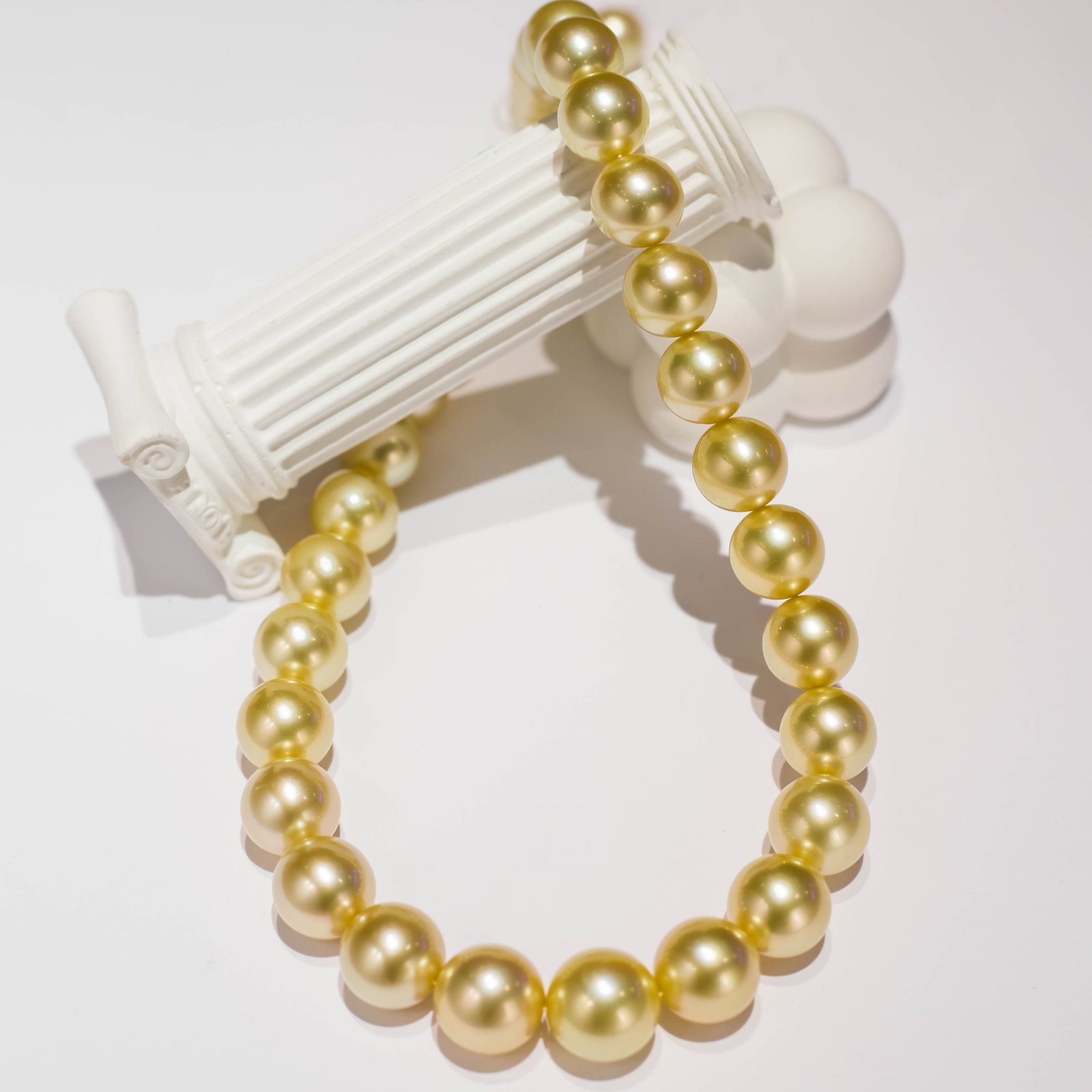 18K Gold Intense Luster South Sea Golden Pearl Necklace: This necklace is meticulously crafted from South Sea golden pearls, showcasing an intense luster and near-round shape. Each pearl is carefully selected to ensure elegance and value. The 18k gold setti