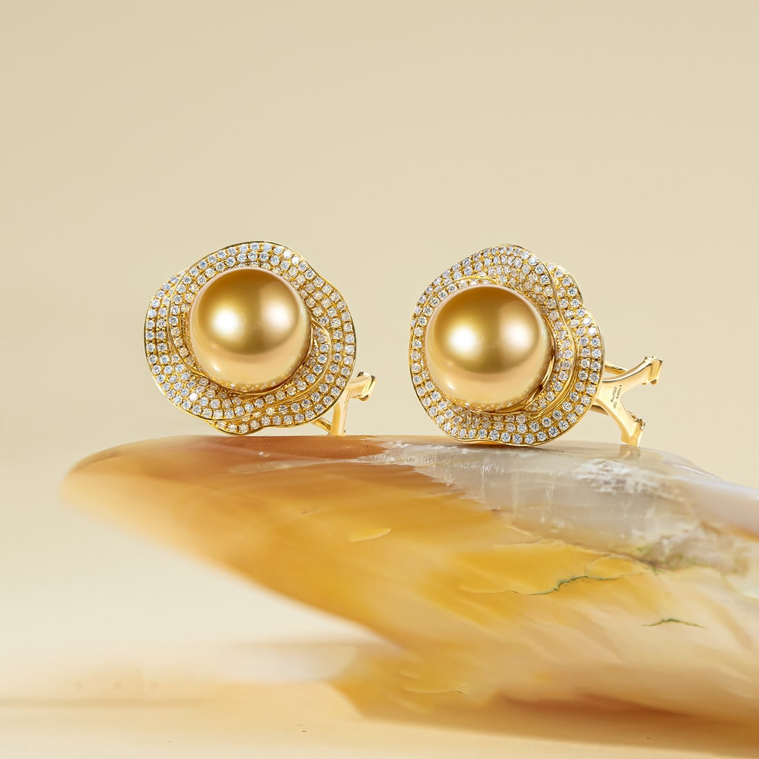 18K Gold South Sea Golden Pearl Earrings: These earrings are meticulously crafted in 18K gold, featuring South Sea golden pearls that exude an aura of elegance and nobility. The lustrous pearls complement the metallic sheen, making them suita