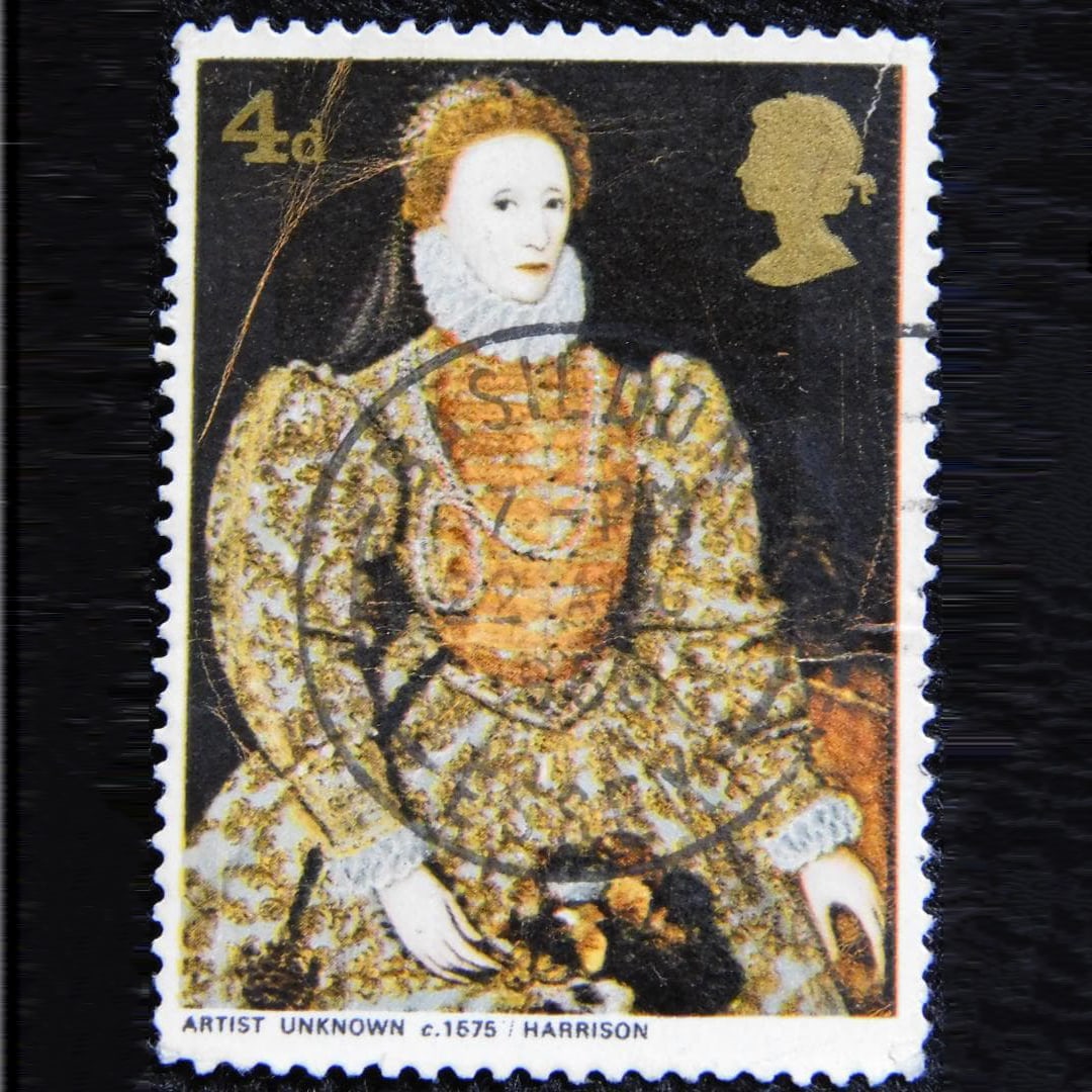 A used 4-pence postage stamp featuring a portrait of Queen Elizabeth I of England.: This is a postmarked (used) stamp. It may bear fingerprints or other marks. Since being preserved as a collectible, it has always been handled with gloves and tweezers. There are noticeable stains,