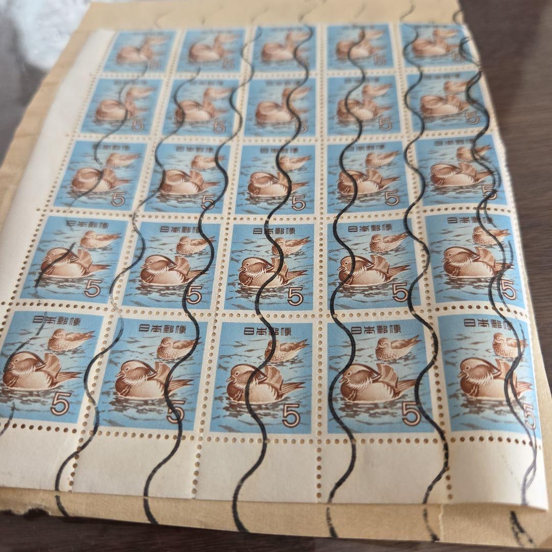 A set of 25 used postage stamps with a face value of 5 yen each.: A sheet of 25 stamps with a face value of 5 yen, featuring a bird floating on the water. Design: Illustration of a bird floating on the water Face Value: 5 yen Sheet Configuration: 25 stamps Colors: B