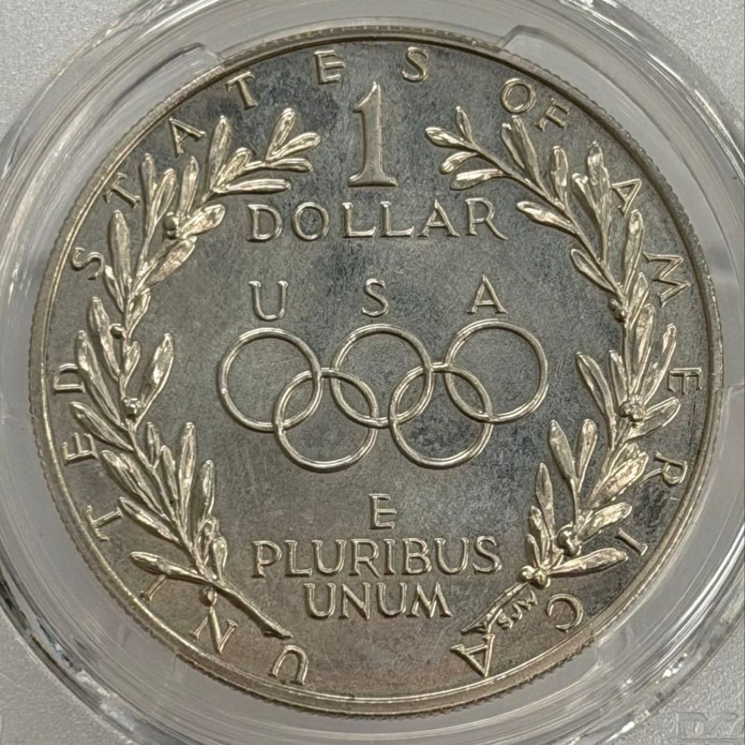 1988 United States Olympic Torch Commemorative Large 1 Dollar Silver Coin, PCGS Certified: This commemorative coin was issued to honor the participation of the United States team in the 1988 Summer Olympics in Seoul, South Korea. It was issued under Public Law 100-141 and approved by Congre